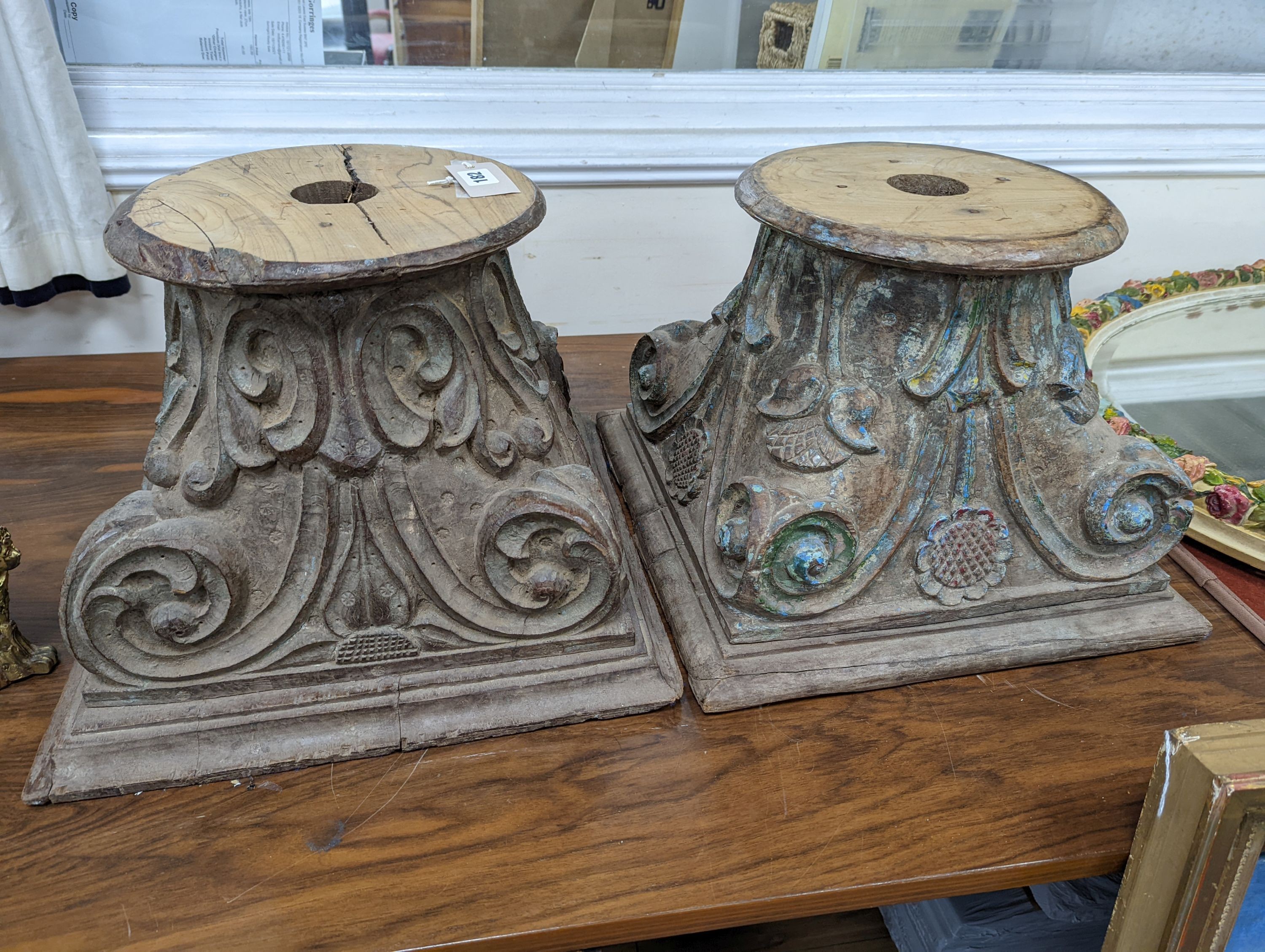 A near pair of carved and painted wood Corinthian column capitals, width 41cm, depth 41cm, height 31cm